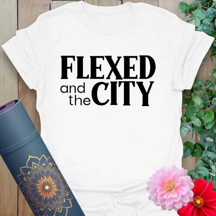 Clean white unisex yoga t-shirt showcasing playful "Flexed and the City" mantra for soulful, strong movers.