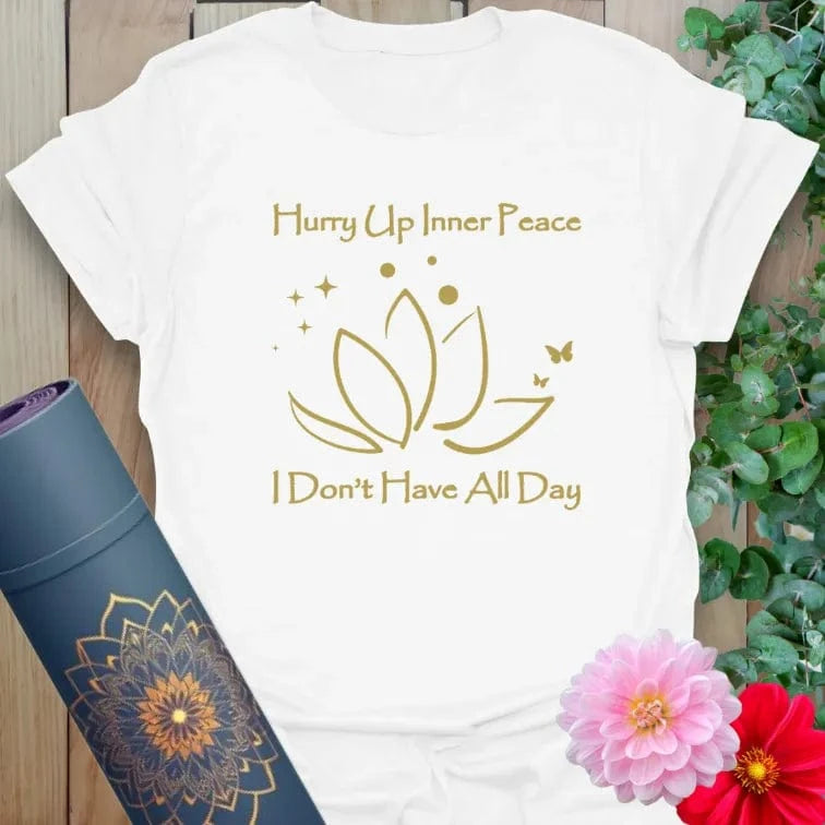 Clean white unisex yoga t-shirt featuring playful "Hurry Up Inner Peace" graphic perfect for mindful, light-hearted living.