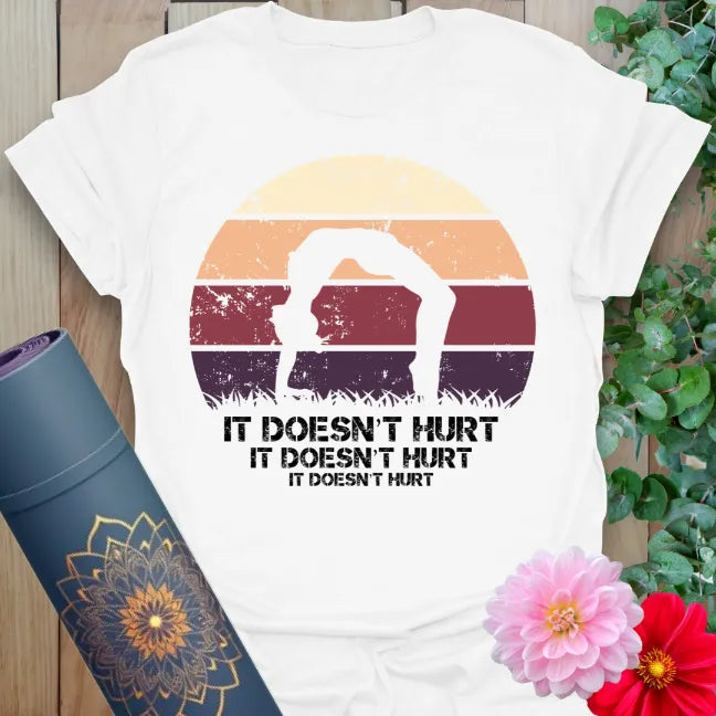 Clean white unisex yoga t-shirt featuring yogi in backbend with funny "It Doesn't Hurt" quote for mindful, light-hearted movement.