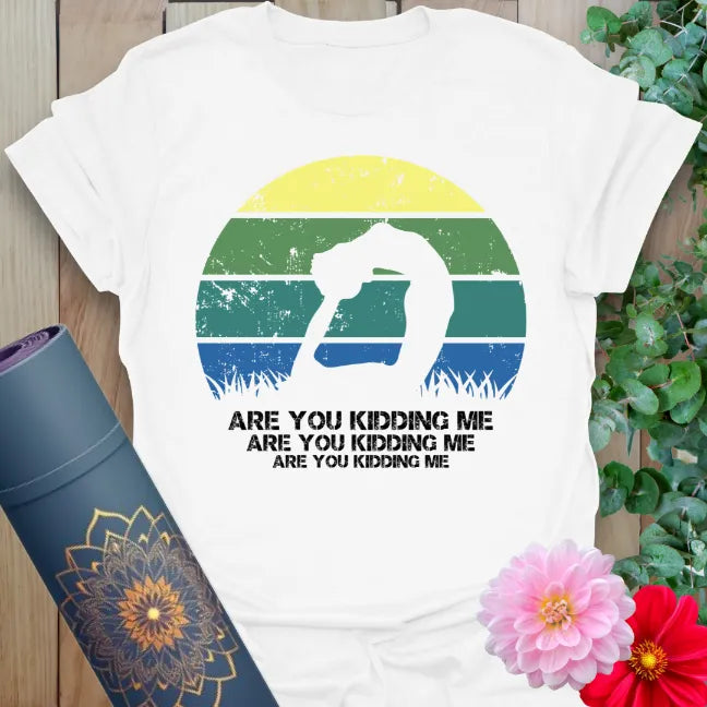 Clean white unisex yoga t-shirt showcasing playful yoga pose and "Are You Kidding Me" mantra for yogis with humor and heart.