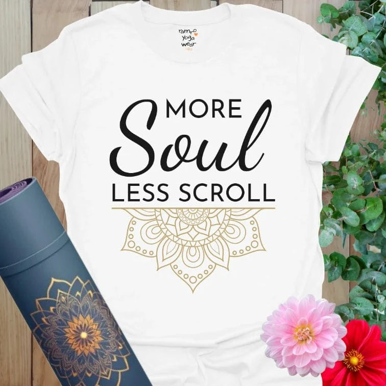 White Less Scroll T-Shirt with bold black script and golden mandala detail. Elegant and mindful statement wear.