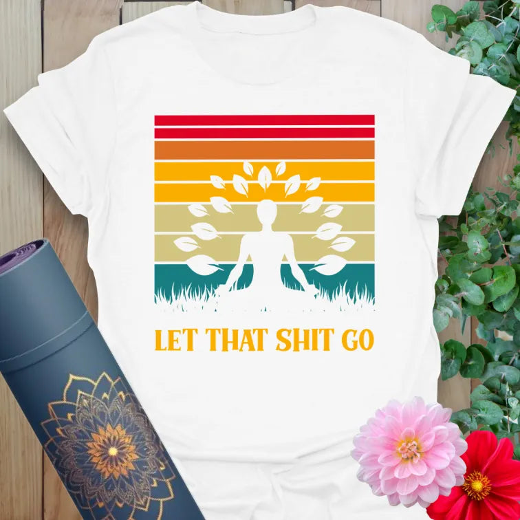 Clean white unisex yoga t-shirt featuring meditative silhouette and "Let That Sh*t Go" playful message for mindful freedom.
