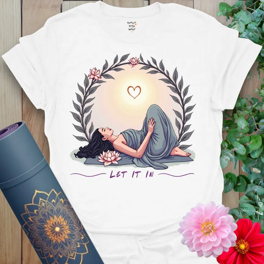 Clean white unisex yoga t-shirt featuring tender yoga pose, sunrise wreath, and "Let It In" mindful living affirmation.