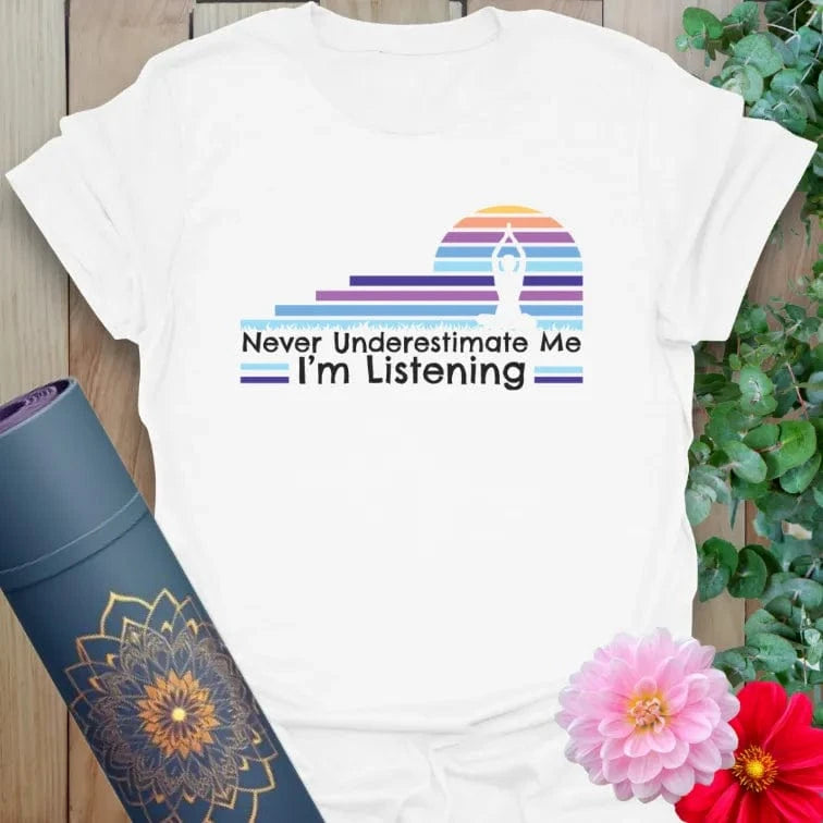 Clean white unisex yoga t-shirt featuring colorful retro sunset and mindful listening empowerment mantra.