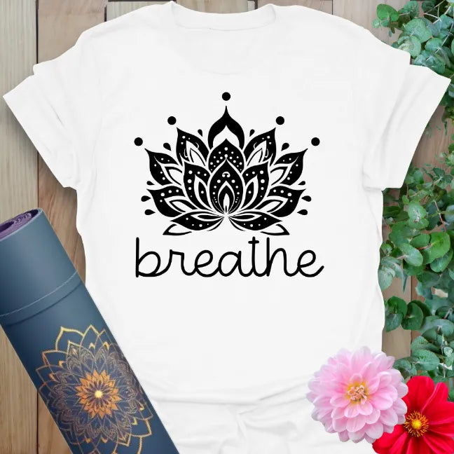 Clean white unisex yoga t-shirt showcasing detailed lotus blossom and "breathe" lettering for conscious, peaceful living.