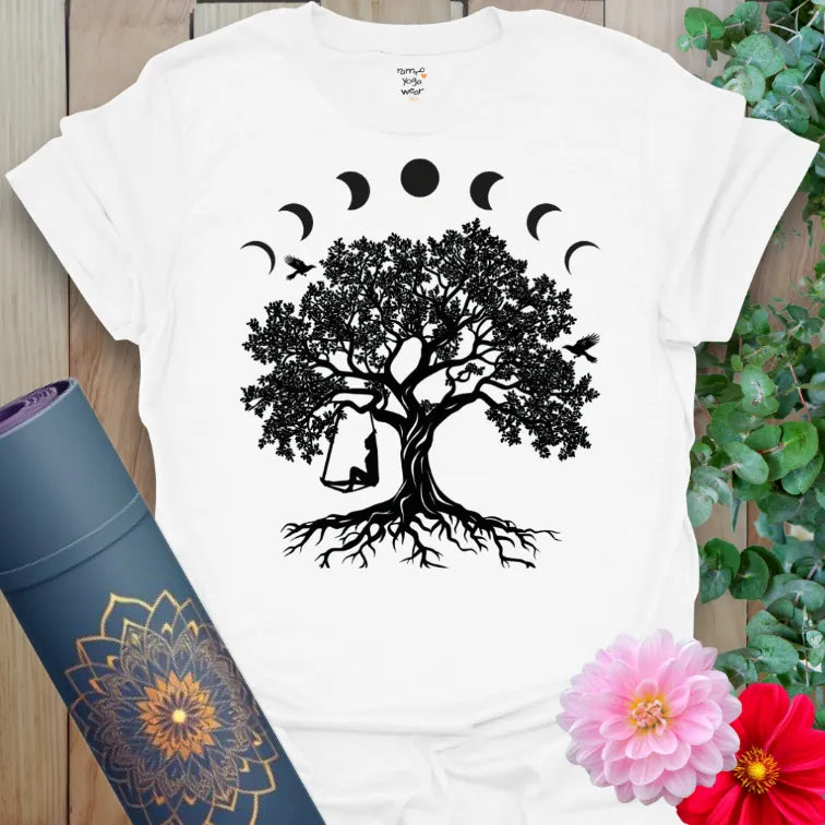 Clean white unisex yoga t-shirt featuring grounded tree, moon phases, and swing design for joyful, mindful journeying.
