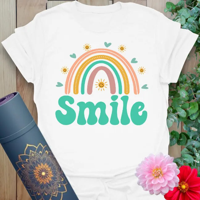 Clean white unisex yoga t-shirt featuring vibrant rainbow and bold "Smile" quote perfect for spreading kindness and soulful joy.
