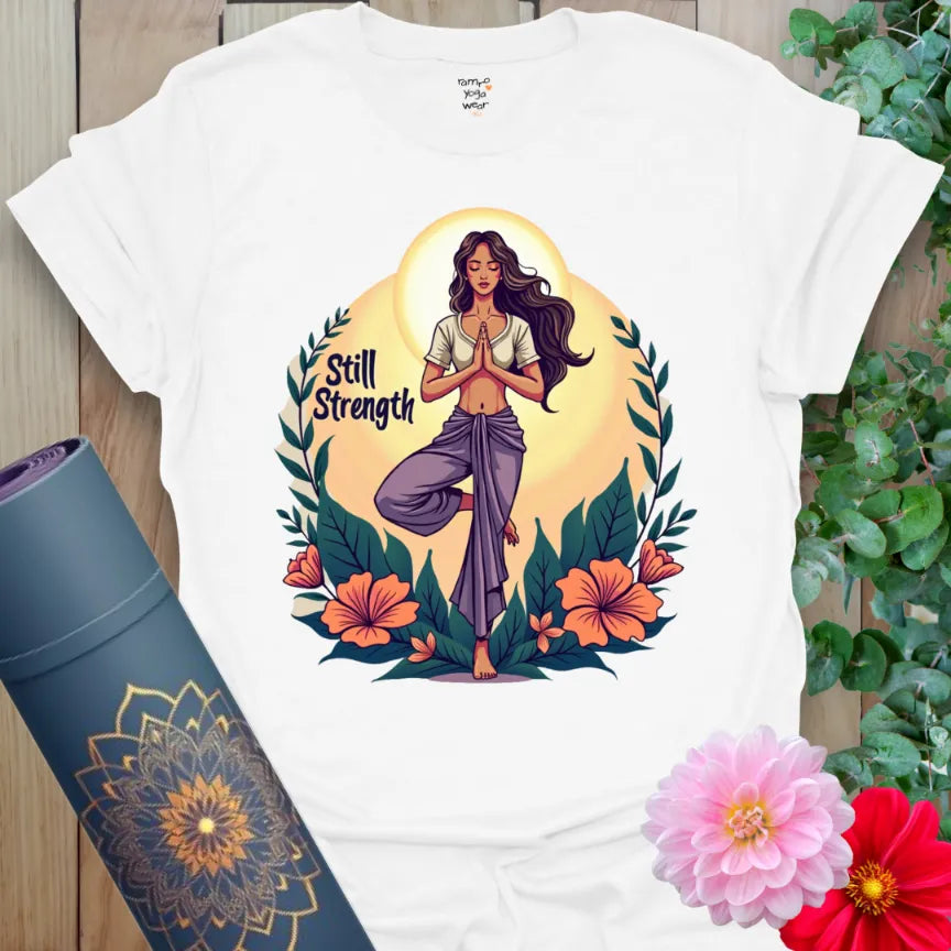 Clean white yoga t-shirt with bold feminine figure in Tree Pose and “Still Strength” design, made for peace and presence.