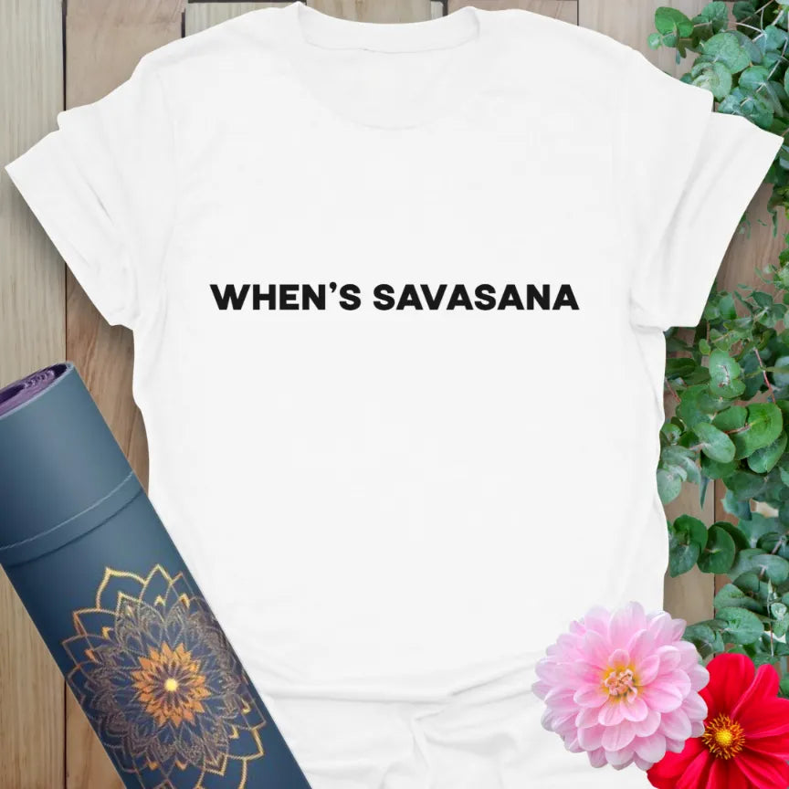 Clean white unisex tee with bold black text that reads “Whens Savasana” — ideal for subtle yoga humor.