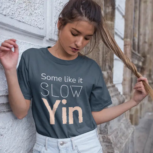 Woman wearing Yin T-Shirt Indigo Blue sacred yoga shirt outdoors against a stone wall — The Vault collection by Ramro Yoga Wear