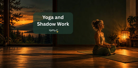 Woman meditating on a mat in a dim room at sunset with a long shadow across the floor, yoga and shadow work in the dark months