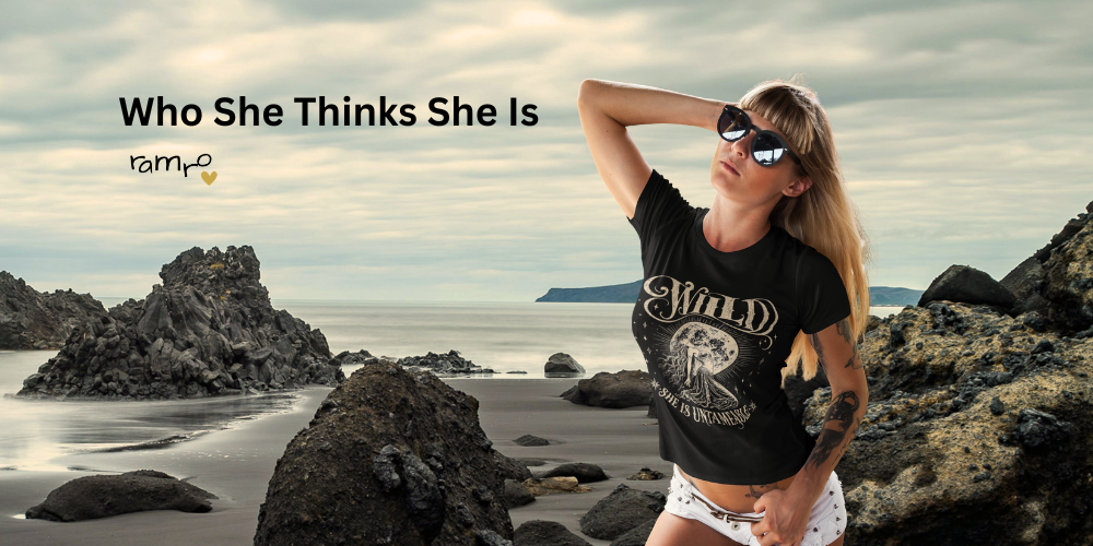 Woman wearing Wild Devotion graphic tee by Ramro Yoga Wear on coastal rocks