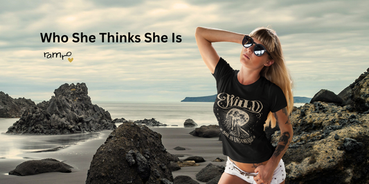 Woman wearing Wild Devotion graphic tee by Ramro Yoga Wear on coastal rocks