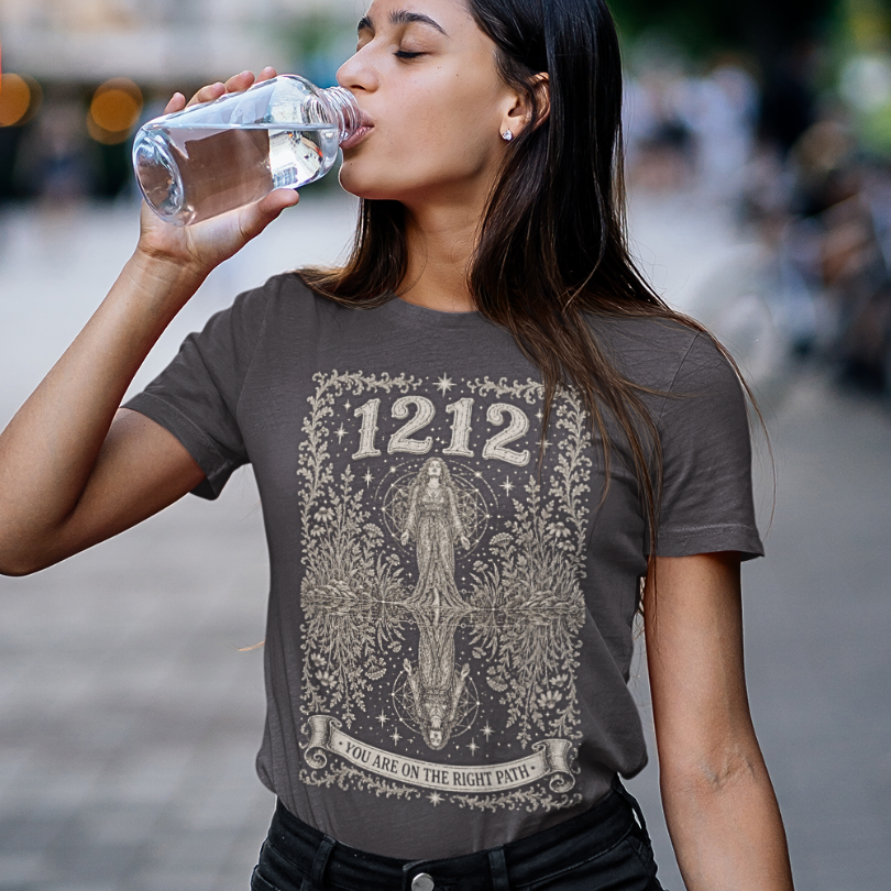 Woman wearing 1212 Dark Heather Grey sacred yoga shirt on a city street — Dark Sacred Stillness collection by Ramro Yoga Wear