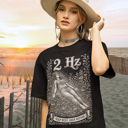 Woman wearing 2 Hz T-Shirt black sacred yoga shirt at the beach at sunset — Dark Sacred Stillness collection by Ramro Yoga Wear