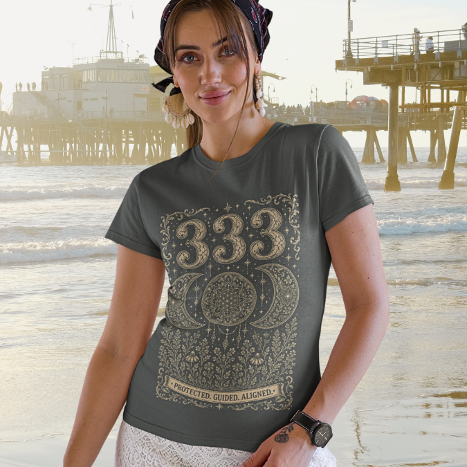Woman wearing 333 dark heather grey angel number meditation shirt at beach — Dark Sacred Stillness collection by Ramro Yoga Wear