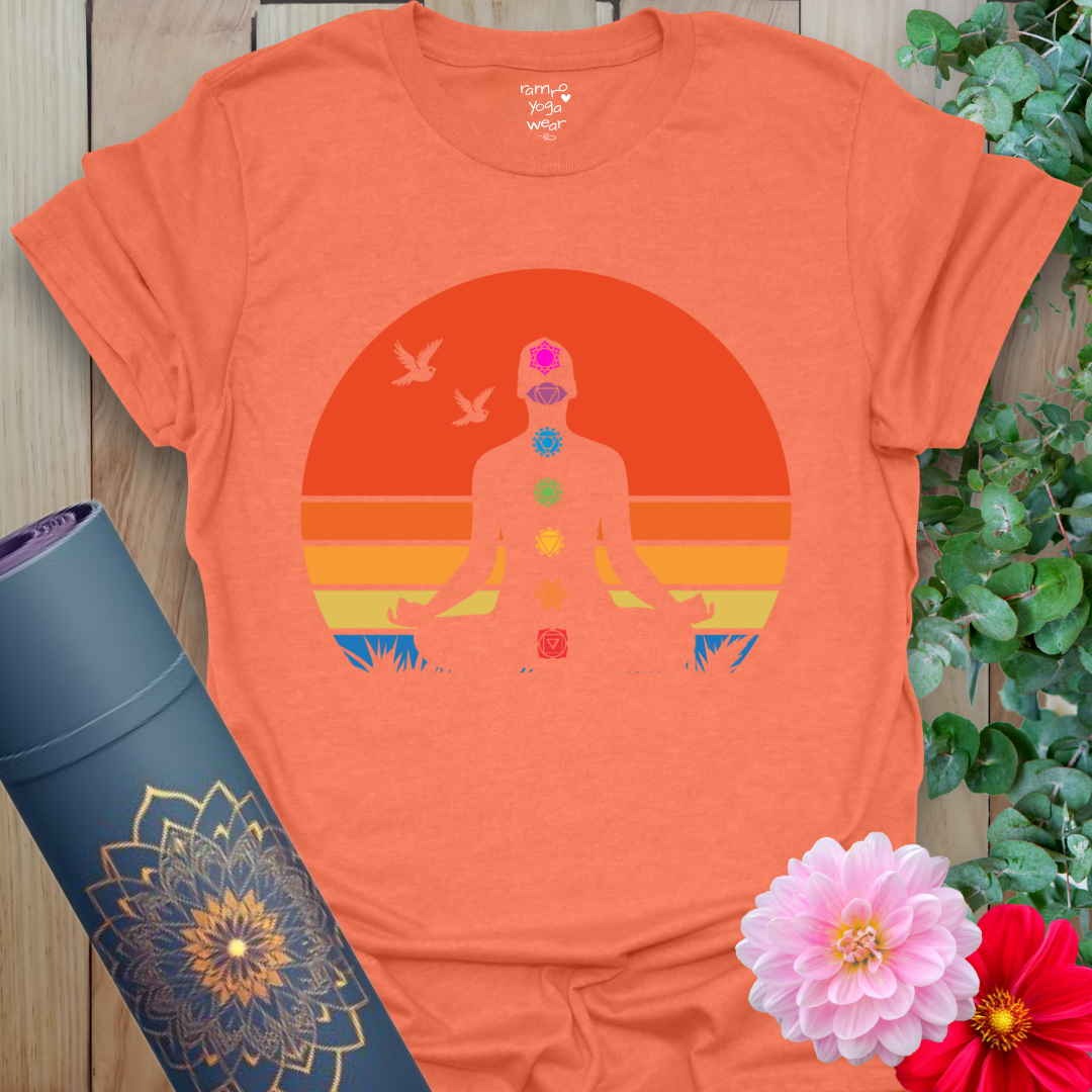 Flatlay of heather orange 7 Chakra T-Shirt with chakra symbols and sunset tones, soft cotton blend.