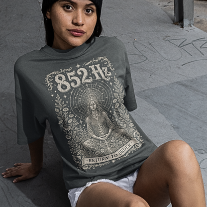 Woman wearing 852 Hz T-Shirt dark heather sacred yoga shirt seated outdoors — Dark Sacred Stillness collection by Ramro Yoga Wear
