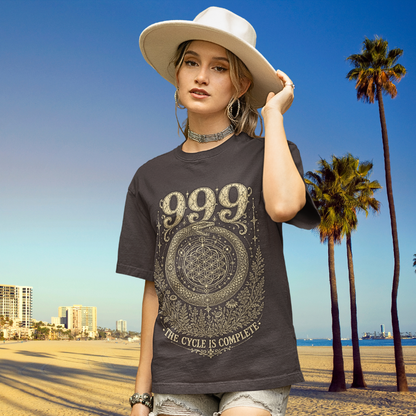 Woman wearing 999 dark heather grey angel number meditation shirt at beach with palm trees — Dark Sacred Stillness collection by Ramro Yoga Wear