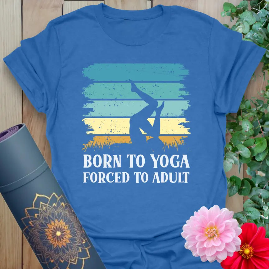 Flatlay of heather royal blue Adult T-Shirt with vintage-style “Born to Yoga, Forced to Adult” print.