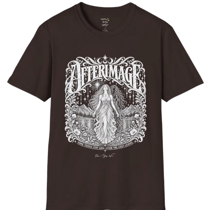 A short sleeved tee called the Afterimage T-Shirt, flat lay and a Gildan 64000 shirt on a white background. Simply says, Some Things Stay Long After The Light Leaves. Design highlights a long-haired figure in a flowing gown standing before a faint ghosted double of herself, under a starry sky with mountains, a lake and an ornate floral frame. Color is Dark Chocolate.