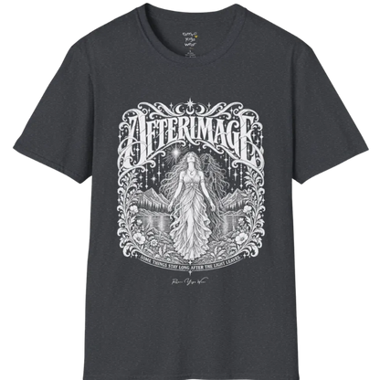 A short sleeved tee called the Afterimage T-Shirt, flat lay and a Gildan 64000 shirt on a white background. Simply says, Some Things Stay Long After The Light Leaves. Design highlights a long-haired figure in a flowing gown standing before a faint ghosted double of herself, under a starry sky with mountains, a lake and an ornate floral frame. Color is Dark Heather Grey.