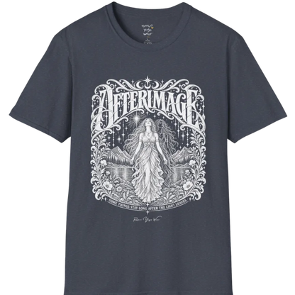A short sleeved tee called the Afterimage T-Shirt, flat lay and a Gildan 64000 shirt on a white background. Simply says, Some Things Stay Long After The Light Leaves. Design highlights a long-haired figure in a flowing gown standing before a faint ghosted double of herself, under a starry sky with mountains, a lake and an ornate floral frame. Color is Heather Navy.