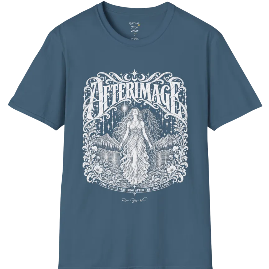 A short sleeved tee called the Afterimage T-Shirt, flat lay and a Gildan 64000 shirt on a white background. Simply says, Some Things Stay Long After The Light Leaves. Design highlights a long-haired figure in a flowing gown standing before a faint ghosted double of herself, under a starry sky with mountains, a lake and an ornate floral frame. Color is Indigo Blue.