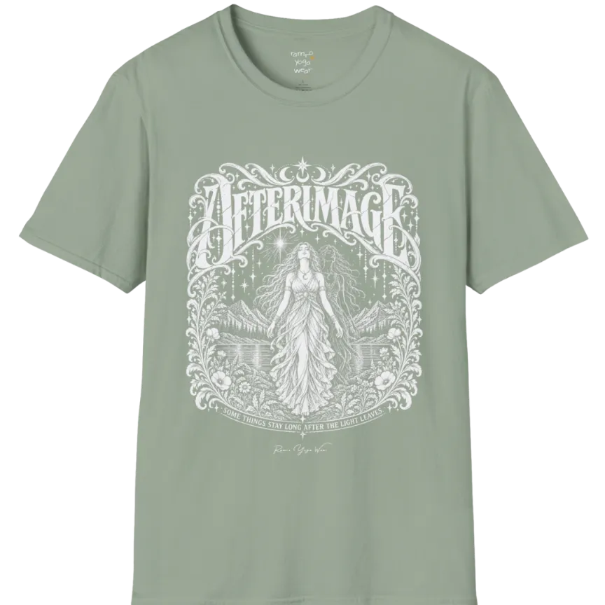 A short sleeved tee called the Afterimage T-Shirt, flat lay and a Gildan 64000 shirt on a white background. Simply says, Some Things Stay Long After The Light Leaves. Design highlights a long-haired figure in a flowing gown standing before a faint ghosted double of herself, under a starry sky with mountains, a lake and an ornate floral frame. Color is Sage.