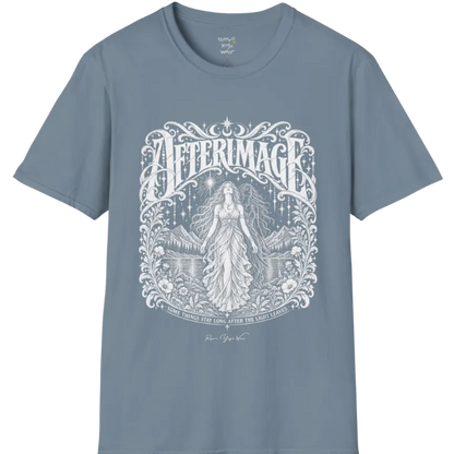 A short sleeved tee called the Afterimage T-Shirt, flat lay and a Gildan 64000 shirt on a white background. Simply says, Some Things Stay Long After The Light Leaves. Design highlights a long-haired figure in a flowing gown standing before a faint ghosted double of herself, under a starry sky with mountains, a lake and an ornate floral frame. Color is Stone Blue.