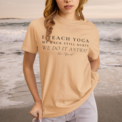 Woman wearing Anyway Heather Peach yoga teacher gift tee on the beach with waves in the background — Yoga Teacher Gifts collection by Ramro Yoga Wear