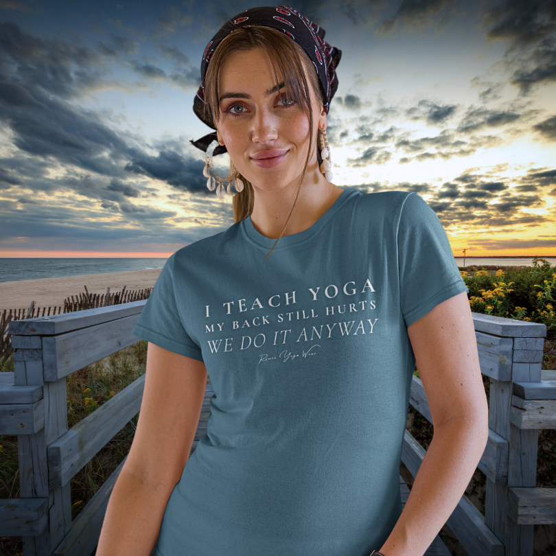 Woman wearing Anyway Heather Deep Teal yoga teacher gift tee on a beach boardwalk at sunset — Yoga Teacher Gifts collection by Ramro Yoga Wear