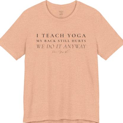 I TEACH YOGA MY BACK STILL HURTS WE DO IT ANYWAY yoga teacher gift tee flat lay in Heather Peach — Yoga Teacher Gifts collection by Ramro Yoga Wear