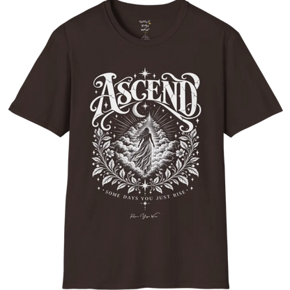 A short sleeved Tee with a figure rising through layered clouds toward a staircase of light, framed by a diamond-shaped botanical border with stars and a crescent moon above. Ascend T-Shirt flat lay is a Gildan 64000 and the color is Dark Chocolate.