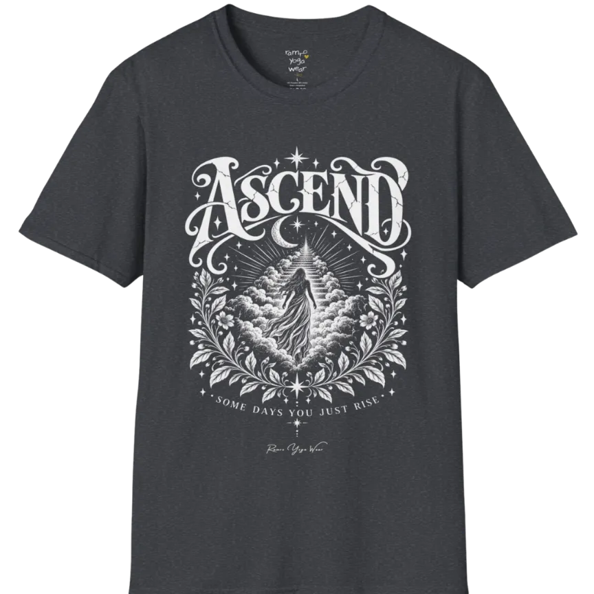 A short sleeved Tee with a figure rising through layered clouds toward a staircase of light, framed by a diamond-shaped botanical border with stars and a crescent moon above. Ascend T-Shirt flat lay is a Gildan 64000 and the color is Dark Heather Grey.