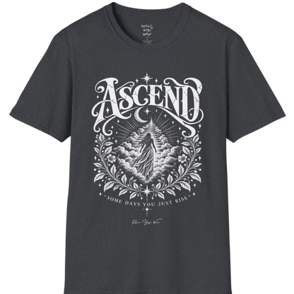 A short sleeved Tee with a figure rising through layered clouds toward a staircase of light, framed by a diamond-shaped botanical border with stars and a crescent moon above. Ascend T-Shirt flat lay is a Gildan 64000 and the color is Dark Heather Grey.