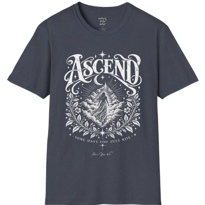 A short sleeved Tee with a figure rising through layered clouds toward a staircase of light, framed by a diamond-shaped botanical border with stars and a crescent moon above. Ascend T-Shirt flat lay is a Gildan 64000 and the color is Heather Navy.