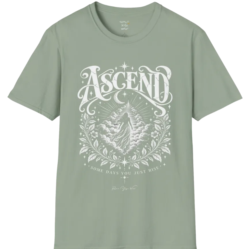 A short sleeved Tee with a figure rising through layered clouds toward a staircase of light, framed by a diamond-shaped botanical border with stars and a crescent moon above. Ascend T-Shirt flat lay is a Gildan 64000 and the color is Sage.