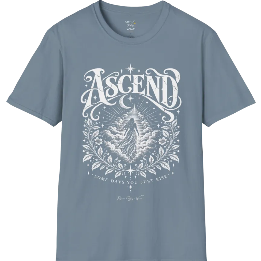 A short sleeved Tee with a figure rising through layered clouds toward a staircase of light, framed by a diamond-shaped botanical border with stars and a crescent moon above. Ascend T-Shirt flat lay is a Gildan 64000 and the color is Stone Blue.