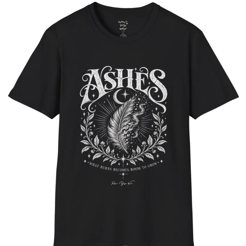 A single feather transforming into ash and ember against a dark starlit background, botanical framing below. Ashes T-Shirt flat lay is a Gildan 64000 and the color is Black.