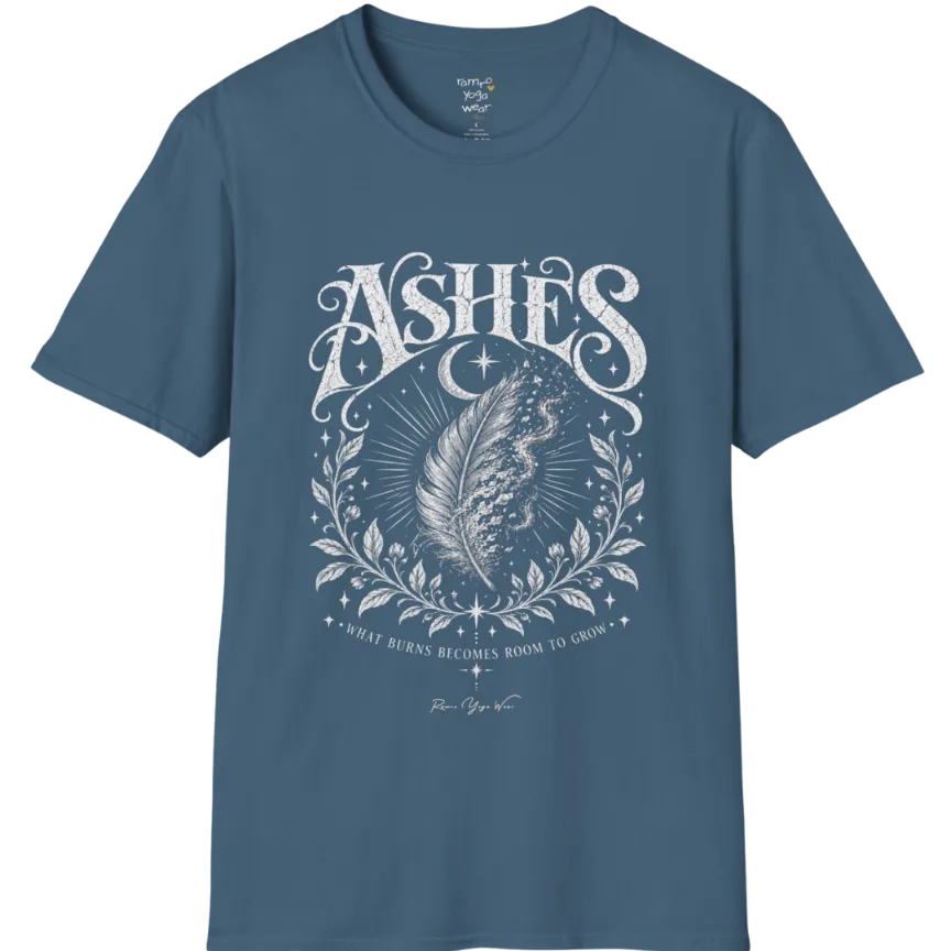 A single feather transforming into ash and ember against a dark starlit background, botanical framing below. Ashes T-Shirt flat lay is a Gildan 64000 and the color is Indigo Blue.