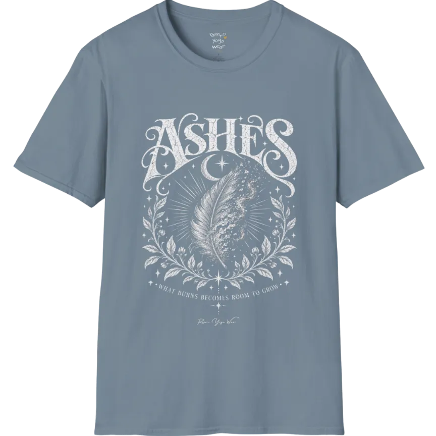 A single feather transforming into ash and ember against a dark starlit background, botanical framing below. Ashes T-Shirt flat lay is a Gildan 64000 and the color is Stone Blue.