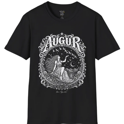 A short sleeved tee called the Augur T-Shirt, flat lay and a soft cotton shirt. Simply says, Some things tell you what's coming, if you look up. Design highlights an ornate engraved circular frame of florals and filigree around a long-haired figure in a flowing gown seated on a rocky ledge, one hand raised toward a flock of birds crossing a starry sky, with crescent moons, mountains and still water behind and Augur in decorative lettering across the top. Color is Black. 