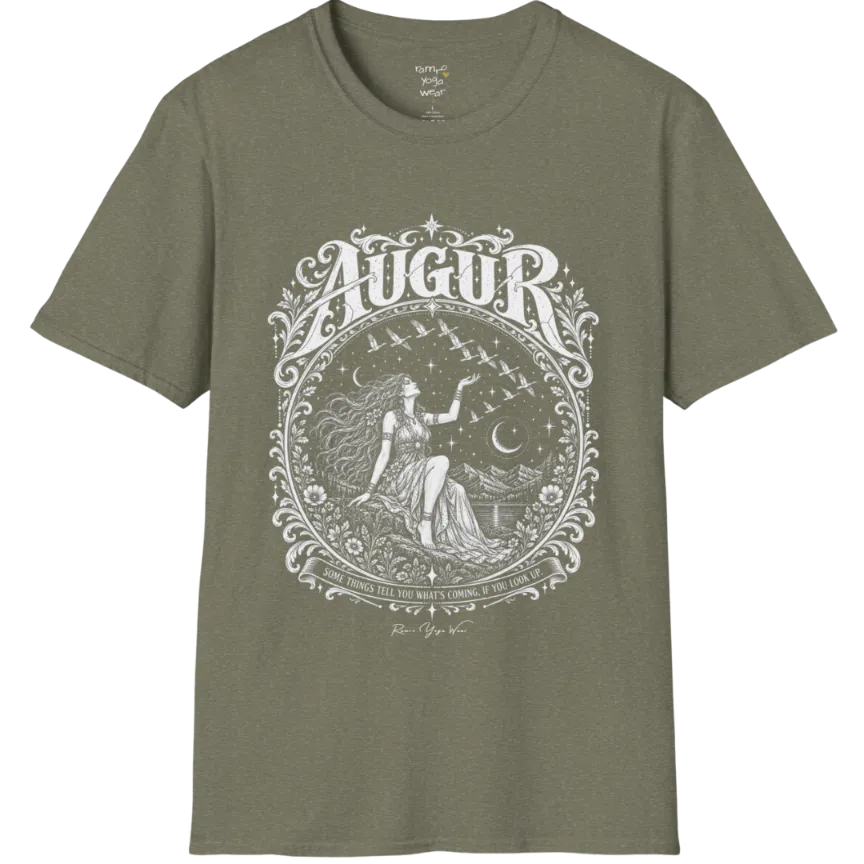 A short sleeved tee called the Augur T-Shirt, flat lay and a soft cotton blend shirt. Simply says, Some things tell you what's coming, if you look up. Design highlights an ornate engraved circular frame of florals and filigree around a long-haired figure in a flowing gown seated on a rocky ledge, one hand raised toward a flock of birds crossing a starry sky, with crescent moons, mountains and still water behind and Augur in decorative lettering across the top. Color is Heather Military Green. 