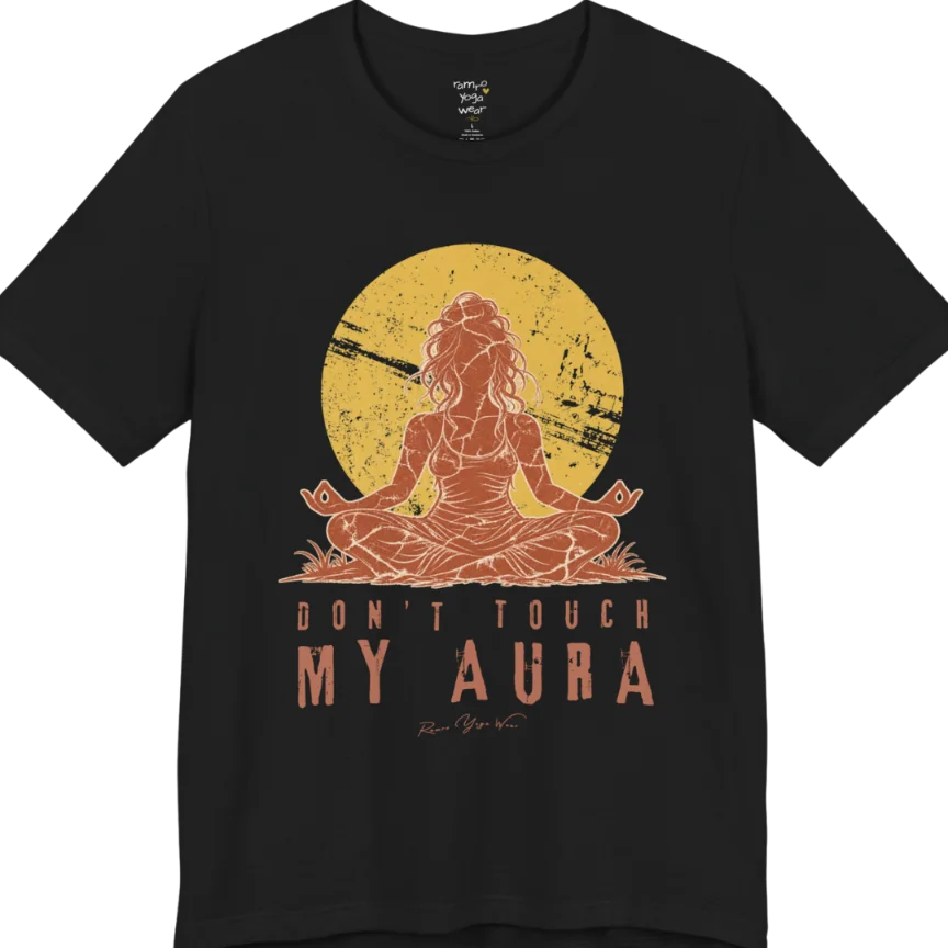 A short sleeved teed called the Aura T-Shirt, flat lay and a Bella + Canvas 3001 shirt. Simply says, Don't Touch My Aura. Design highlights a person meditating with a large bright sun in the background, all in a rustic, distressed illustration. Color is  Black.