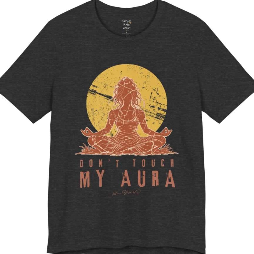 A short sleeved teed called the Aura T-Shirt, flat lay and a Bella + Canvas 3001 shirt. Simply says, Don't Touch My Aura. Design highlights a person meditating with a large bright sun in the background, all in a rustic, distressed illustration. Color is Dark Grey Heather.