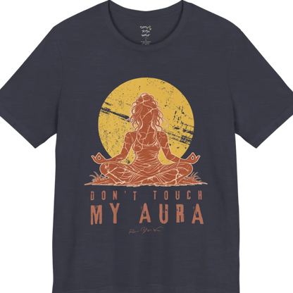 A short sleeved teed called the Aura T-Shirt, flat lay and a Bella + Canvas 3001 shirt. Simply says, Don't Touch My Aura. Design highlights a person meditating with a large bright sun in the background, all in a rustic, distressed illustration. Color is Heather Midnight Navy.