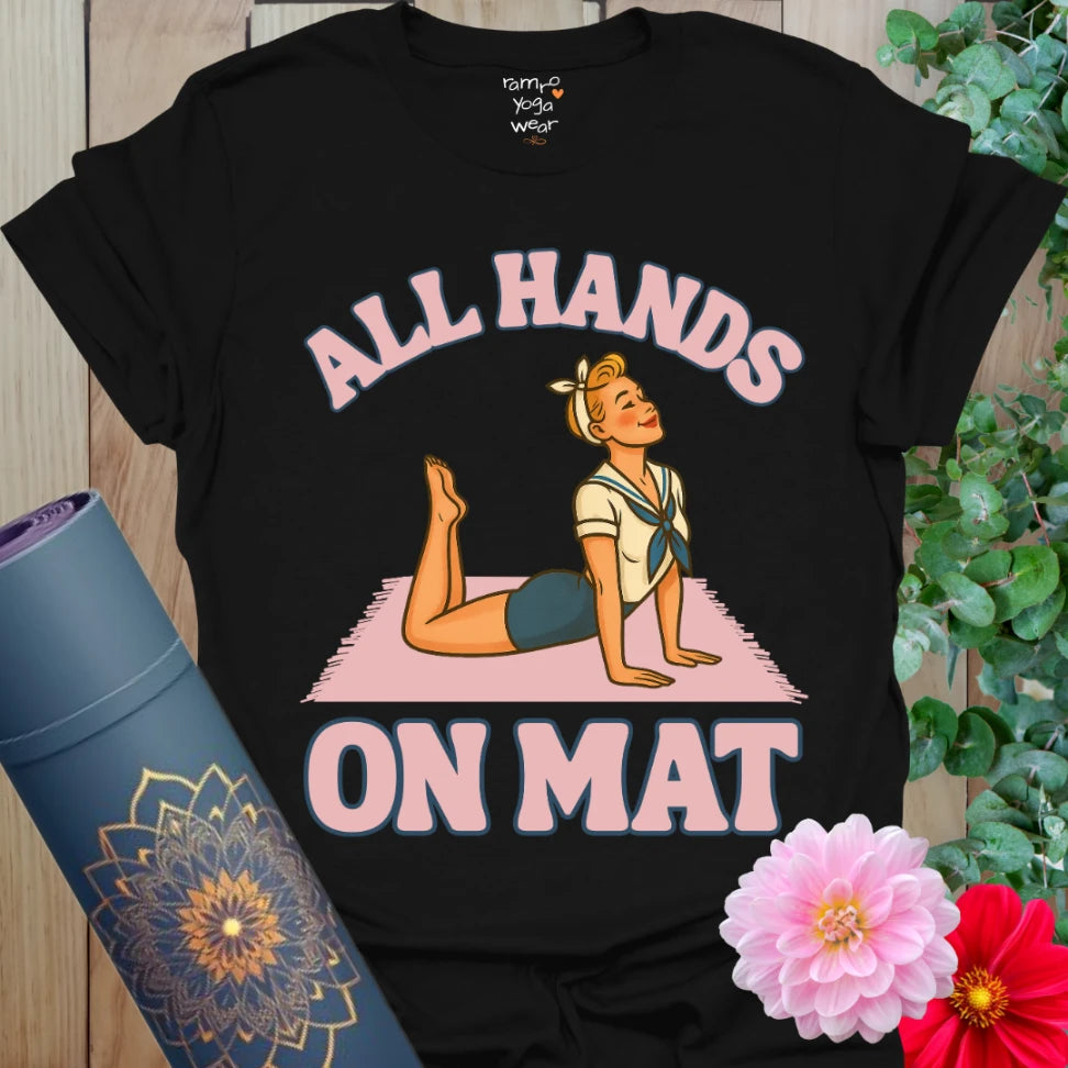 Classic black yoga t-shirt with playful pinup girl in Cobra Pose and “All Hands on Mat” slogan for fun, mindful movement.
