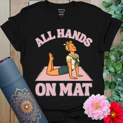 Classic black yoga t-shirt with playful pinup girl in Cobra Pose and “All Hands on Mat” slogan for fun, mindful movement.