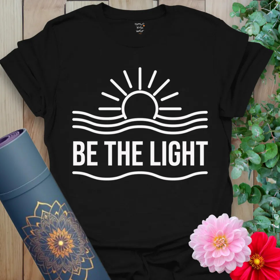 Black yoga tee with minimalist sunrise and "Be the Light" inspirational print.